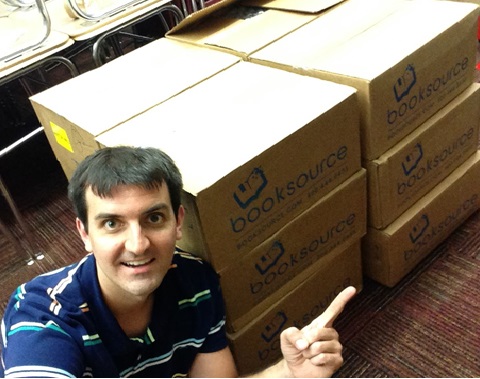 Dowling High School English Teacher Austin Hall poses with the books he received from the Book Love grant.